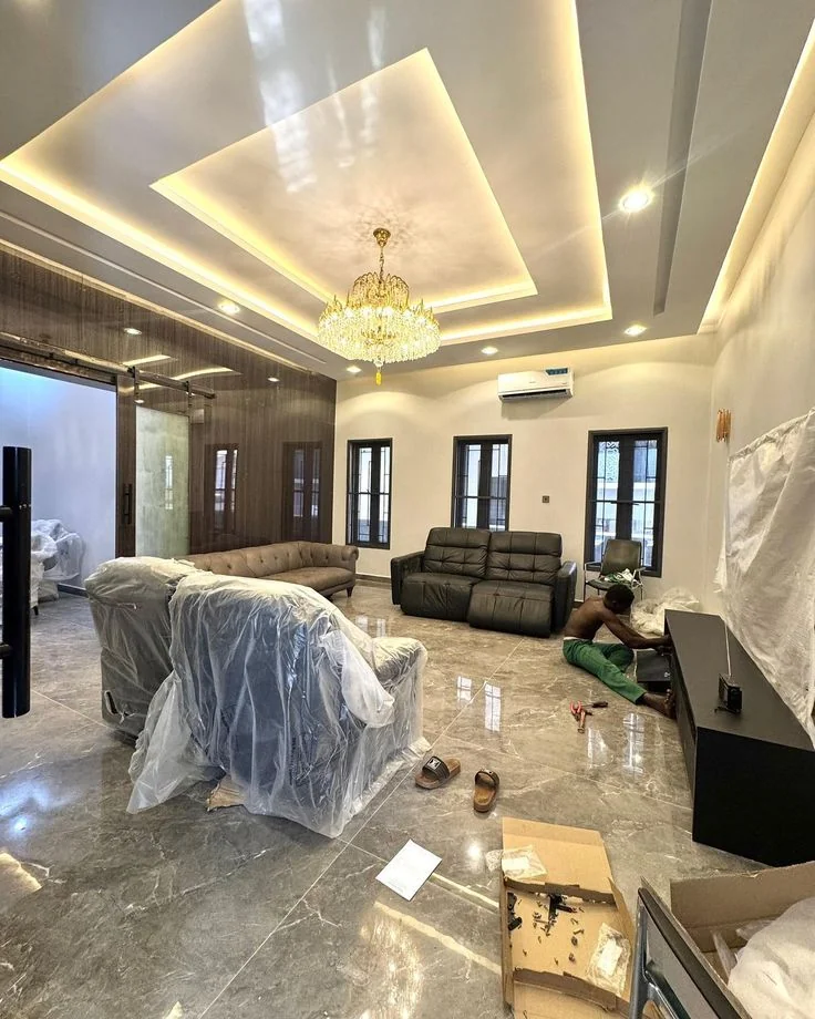 Luxury living room crystal chandelier installation with false ceiling Dubai